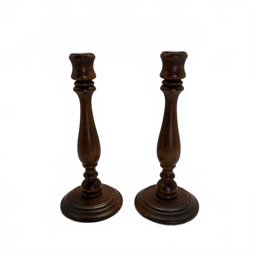 A pair of vintage turned wooden candlesticks with brass inserts.